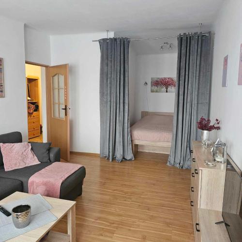 a living room with a couch and a bed at Rynek-Centrum in Olsztynek