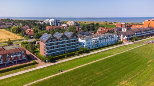 an aerial view of a city with buildings and a field at Haus Seepferdchen in Schillig