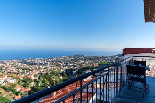 a chair on a balcony with a view of the ocean at GuestReady - Private Terrace Stay in Funchal