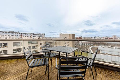 une table et des chaises sur un balcon avec vue dans l'établissement GuestReady - Charming Family Duplex with a terrace, à Paris