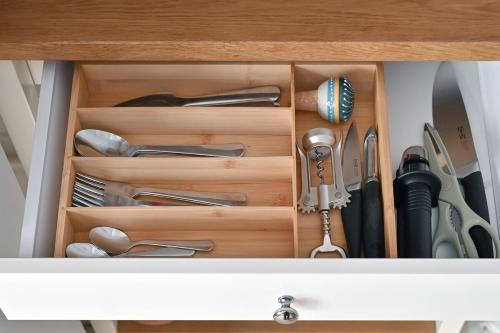 a drawer full of utensils in a cabinet at Heart of Riga Old Town - Walk to Everything! in Rīga
