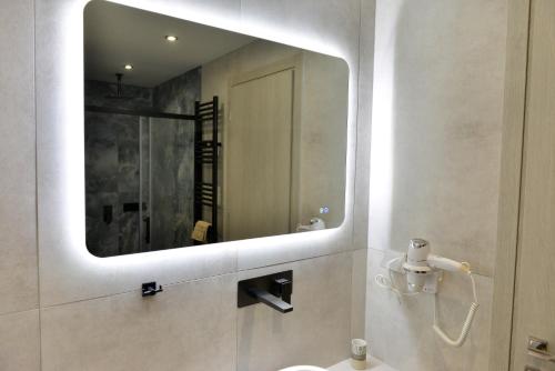 a bathroom with a mirror and a sink at Krya Suites in Levádeia