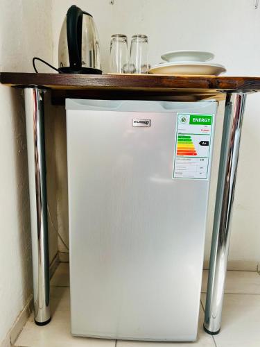 a white refrigerator with a counter on top of it at Ashridge Guesthouse & Safaris in Hazyview