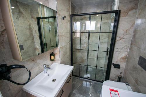 a bathroom with a sink and a shower and a toilet at Luxury Life Suites in Istanbul