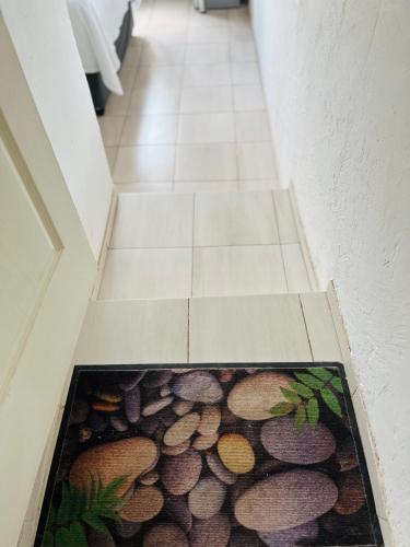 a hallway with a floor mat with logs on it at Ashridge Guesthouse & Safaris in Hazyview