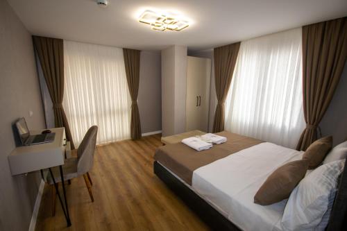 a bedroom with a bed and a desk with a computer at Luxury Life Suites in Istanbul