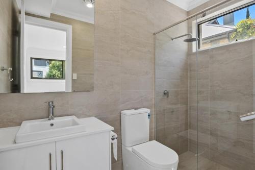a bathroom with a toilet and a sink and a shower at Prospect High Street House in Prospect