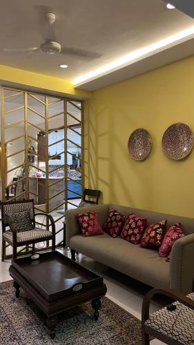 a living room with a couch and a table at Luxury homes in Hyderabad