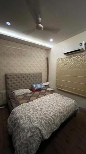 a bedroom with two beds and a wall at Luxury homes in Hyderabad