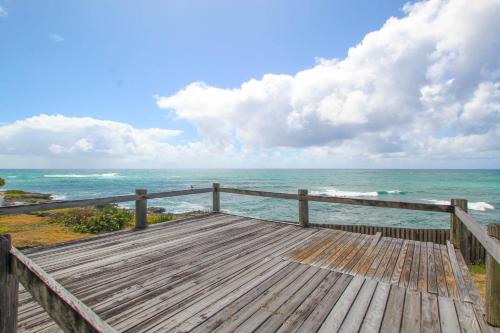 a wooden pier with the ocean in the background at Inch by Inch home by Bluescape in Christ Church