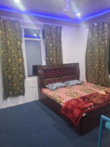 a bedroom with a bed in a room with curtains at Gulzar Guest house 6bhk in Srinagar