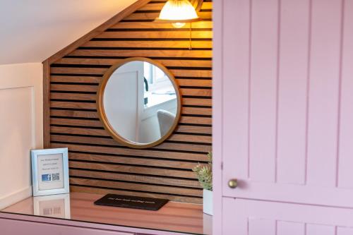 a mirror on a wall in a room at Holly Lodge Guest House with FREE off site health club in Windermere