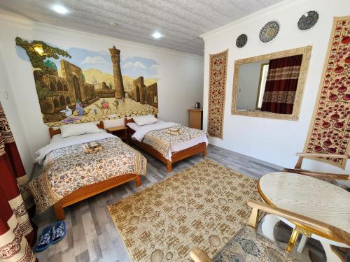 a room with two beds and a painting on the wall at Samani Bukhara in Bukhara