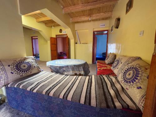a bedroom with a large bed and a table at Gite Megdaz in Megdaz