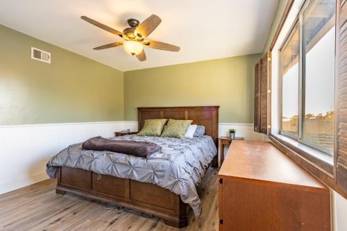 a bedroom with a bed and a ceiling fan at Spacious 4BR Retreat near Disneyland & Beaches in Placentia