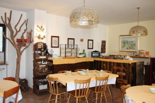 a dining room with a table and chairs at Antica Dimora del Portico in Borgiallo