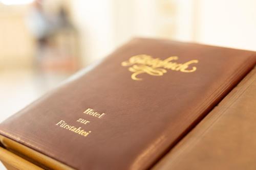 a brown book sitting on top of a table at Hotel zur Fürstabtei in Herford