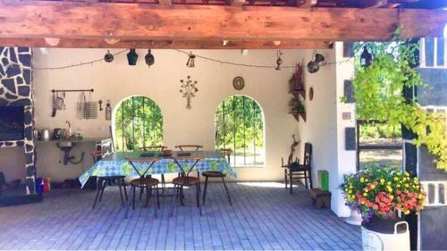 a patio with a table and chairs in a building at Casa Lerryn in Sertã