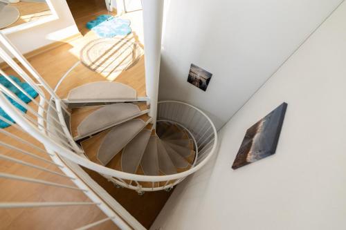 an overhead view of a spiral staircase in a house at Lake Breeze Maisonette bei Leipzig in Markkleeberg