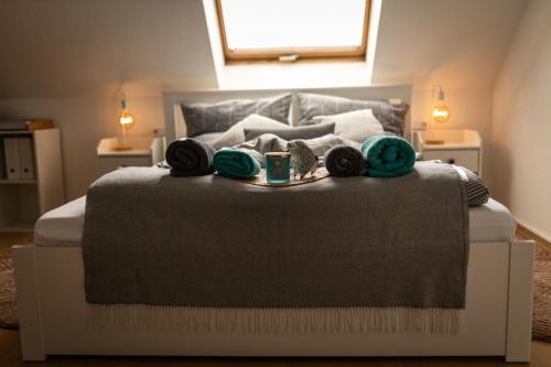 a bedroom with a large bed with green objects on it at Lake Breeze Maisonette bei Leipzig in Markkleeberg