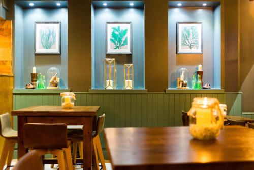 a table and chairs in a restaurant with glass vases at The Old Custom House in Padstow