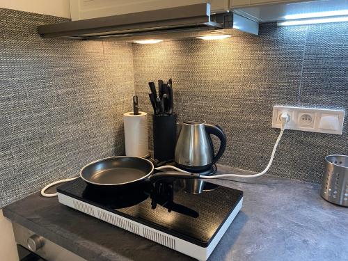 a kitchen counter with a frying pan and utensils at NEW apartment in Prague in Prague