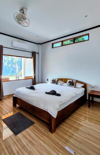 a bedroom with a large bed and a window at Amanda Boutique in Nongkhiaw