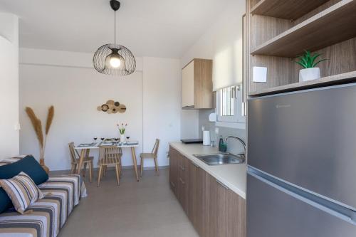 a kitchen and living room with a couch and a table at Avra 1 modern seaview home in Tsoútsouros