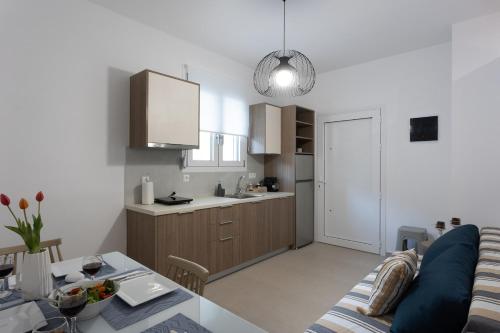 a living room and kitchen with a couch and a table at Avra 1 modern seaview home in Tsoútsouros