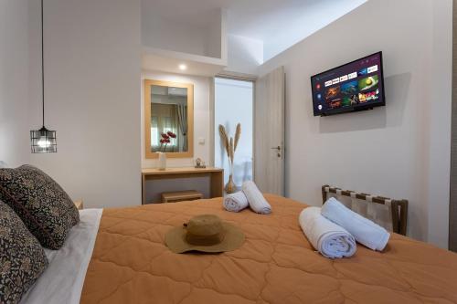 a bedroom with a large bed with a hat on it at Avra 1 modern seaview home in Tsoútsouros