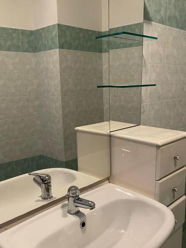 a bathroom with a sink and a toilet and a mirror at Casa Teodoro - Gelsomino, Ulivi & Orchidea in Tignale