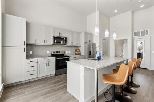 a kitchen with white cabinets and a counter top at Luxury Loft Style Apartment in Austin