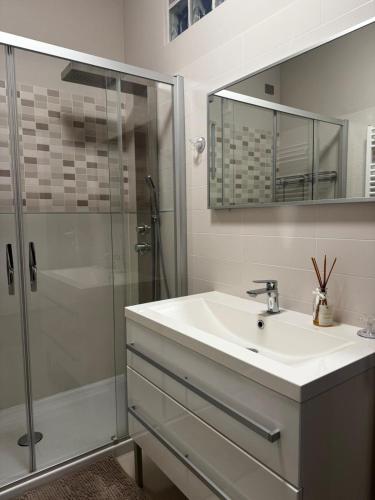 a white bathroom with a sink and a shower at "Casa Viola" via Camillo CARLOMAGNO 26 in Isernia