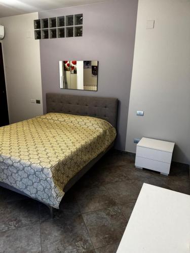a bedroom with a bed and a table and a mirror at "Casa Viola" via Camillo CARLOMAGNO 26 in Isernia