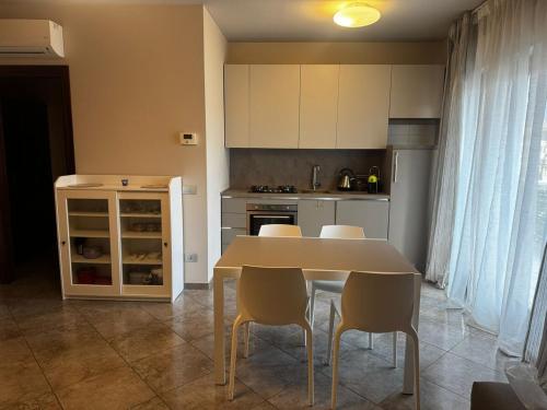 a kitchen with a table and chairs and a kitchen with a stove at "Casa Viola" via Camillo CARLOMAGNO 26 in Isernia