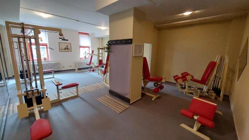 a room with a bunch of chairs in a gym at Hotel Belaria Resort - wellness, bazén in Opava