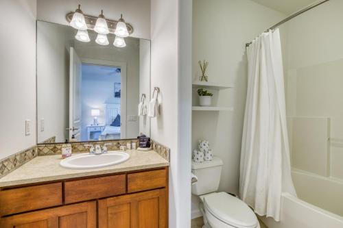 a bathroom with a sink and a toilet and a mirror at The River View on Riverview Way in Quincy