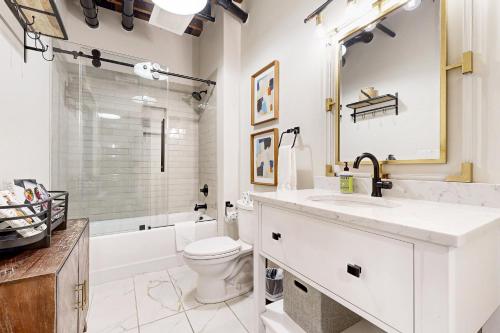 a white bathroom with a sink and a toilet at All Access Pass #104 in Nashville