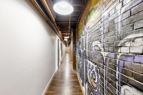 a hallway with graffiti on a brick wall at All Access Pass #104 in Nashville