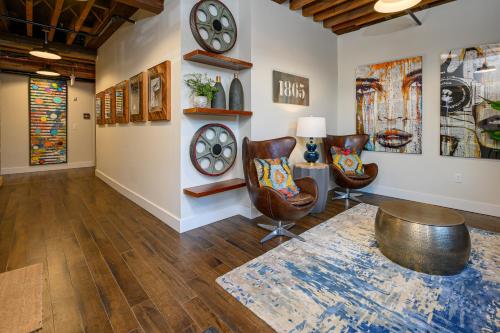 a living room with chairs and a clock on the wall at All Access Pass #104 in Nashville