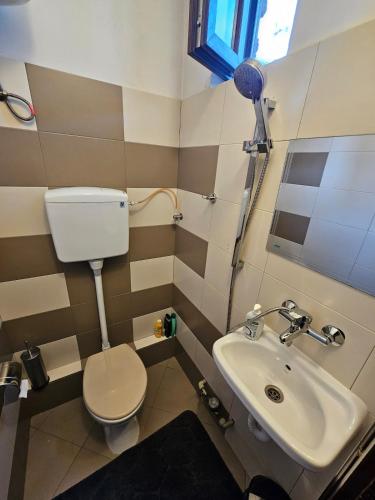 a small bathroom with a toilet and a sink at Hot Spot 2bdrm apartment 1 in Sofia