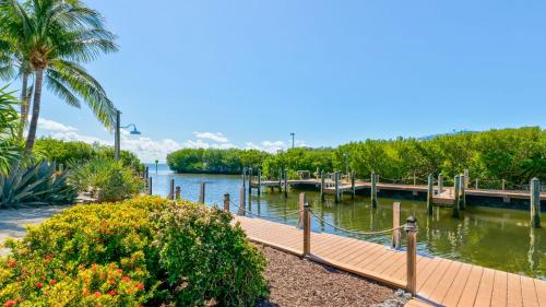 a dock with a wooden walkway next to a body of water at Ocean View Treehouse Double King Suite 3403 in Tavernier