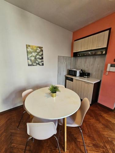 a kitchen with a table and chairs in a room at Hot Spot 2bdrm apartment 1 in Sofia