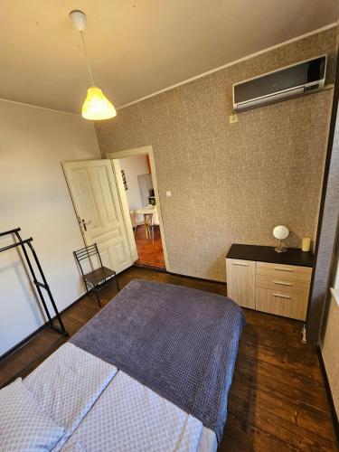 a bedroom with a bed and a room with a table at Hot Spot 2bdrm apartment 1 in Sofia