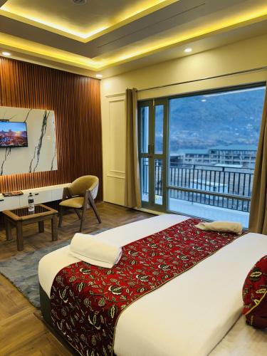 a bedroom with a large bed and a large window at Hotel Falcon heights in Anantnāg