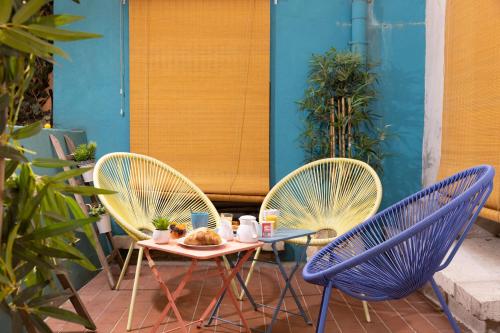 two chairs and a table with a plate of food on a patio at Hotel Victoria in Paris