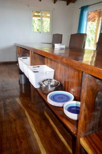 a kitchen with a wooden counter with plates on it at Casa Marea in Cambutal
