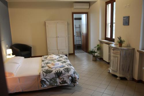 a bedroom with a bed and a dresser in it at Cascina La Goliarda in Curtatone
