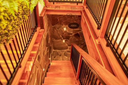 a staircase in a building with a stone wall at Hospedaria Morada das Grimpas in Palmeira