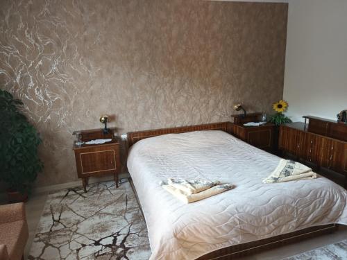 a bedroom with a bed with two towels on it at Guest House Stoletnika in Yagodina